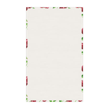 Backside of the White tea towel featuring a vibrant cherry print with green leaves.