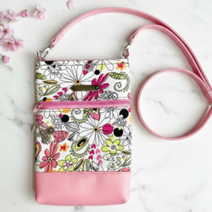 a pink floral double zip crossbody bag by Lisa Bousson.