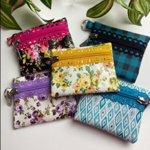 Each handmade mini zipper pouch in this collection is distinguished by a decorative lace zipper and a streamlined design. Handmade for convenience, these pouches offer ample space for cards and coins while remaining sufficiently low-profile to serve as a functional keychain accessory.